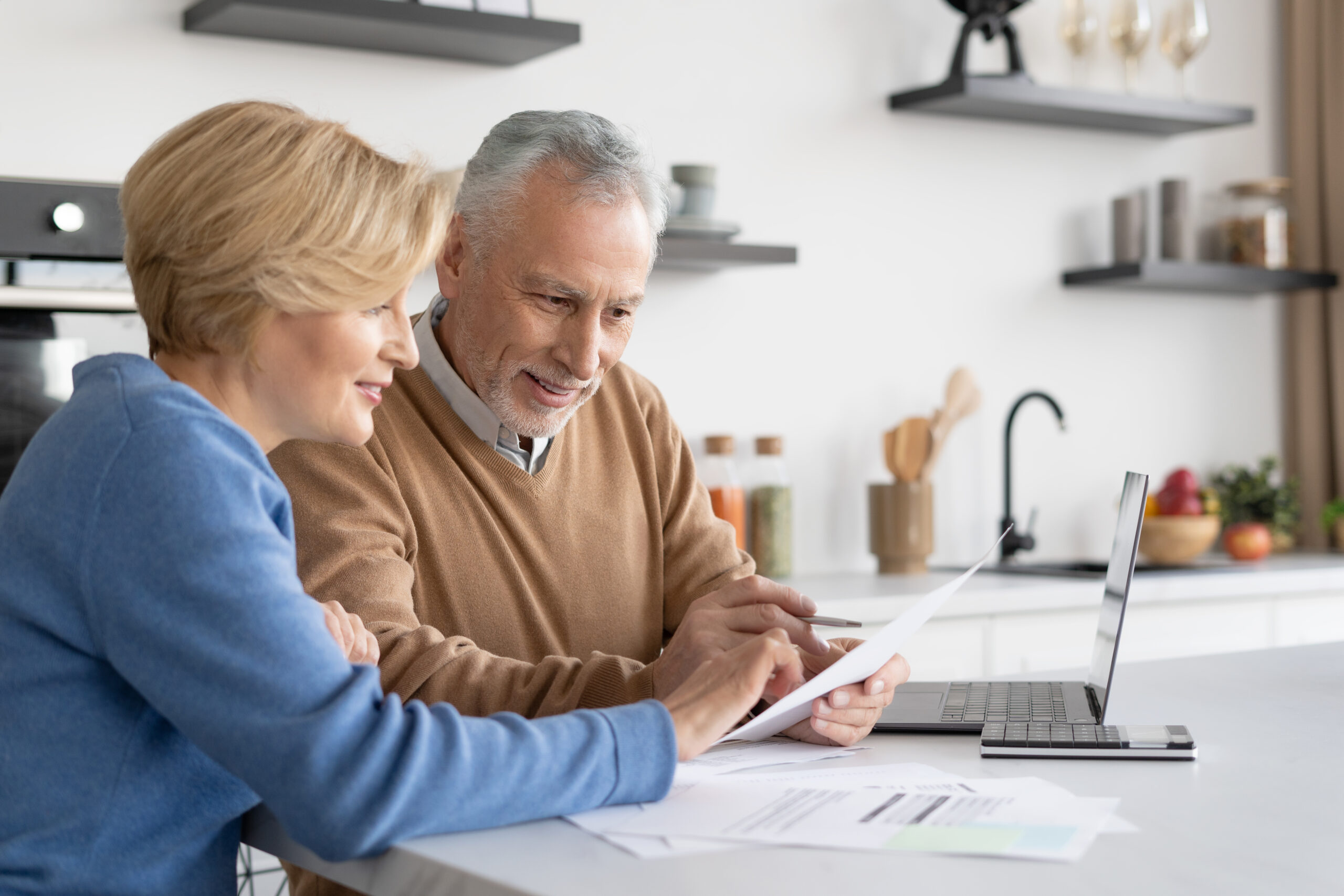 senior couple paying bills reverse mortgage concept